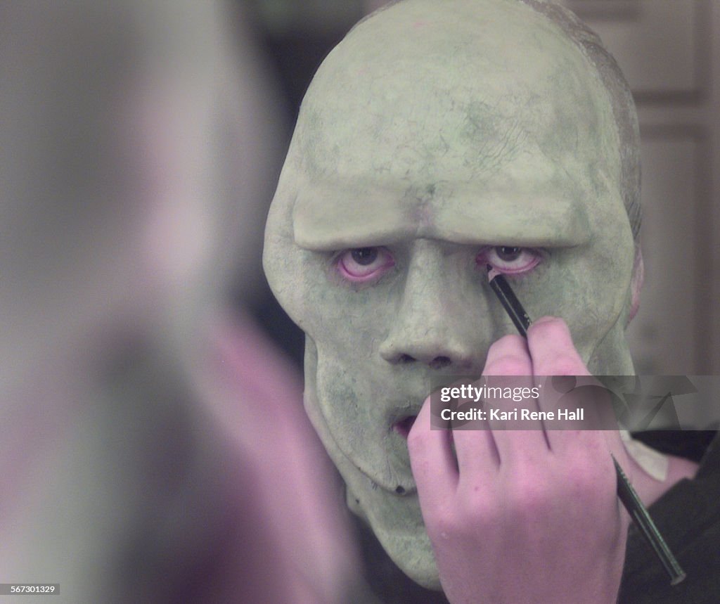 ME.Makeup.green.D.052898.KRHJerry Paxton, 19, of Riverside applies eyeliner pencil as one of the f