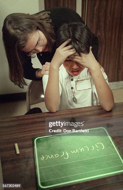 Spell.Lost.DB.f4/10/97.GardenGrove. Competing for one of the finalist places, Thinh Nguyen from Carrillo School is given a pat by a judge when he...