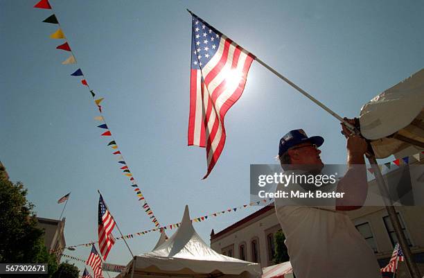 Fair.Flag..8.30.96.MB Orange International street fair readies for half million visitors this Labor Day weekend. Booths fill the Traffic Circle and...