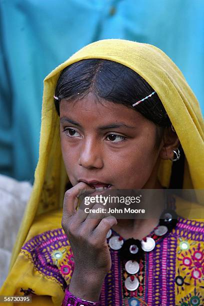 Girl from the Marri tribe listens to elders speak after returning to the town of Kahan on February 1, 2006 in the Pakistani province of Balochistan....