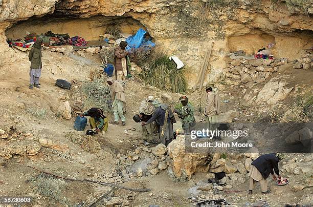 Marri tribal guerrillas begin to prepare a meal in their rebel camp outside of the town of Kahan on February 1, 2006 in the Pakistani province of...
