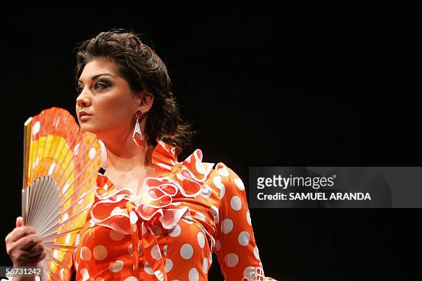 Model presents an outfit by Lole Vera during the XII International Flamenco Fashion Show in Seville, 02 February 2006. AFP PHOTO/Samuel Aranda