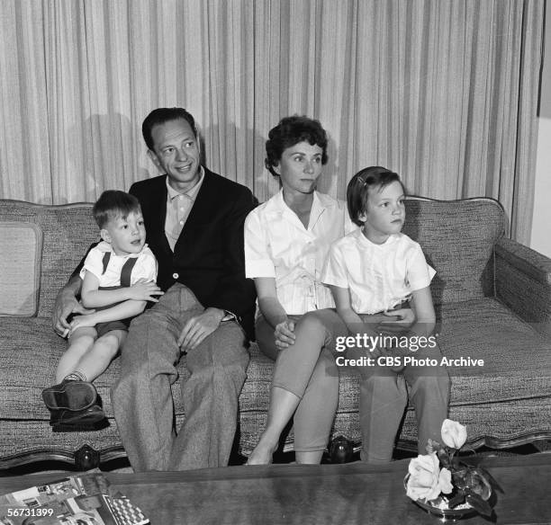 American television actor Don Knotts sits on a couch with his family at home, March 2, 1961. From left, son Tom, Knotts, wife Kay, and daughter Karen.