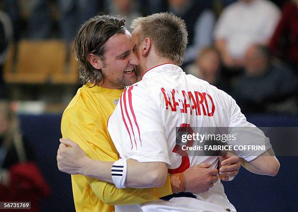 Denmark goalkeeper Kristian Asmussen and teammate Mikkel Aagaard celebrate their victory 35-28 over Russia during their main round game at the...