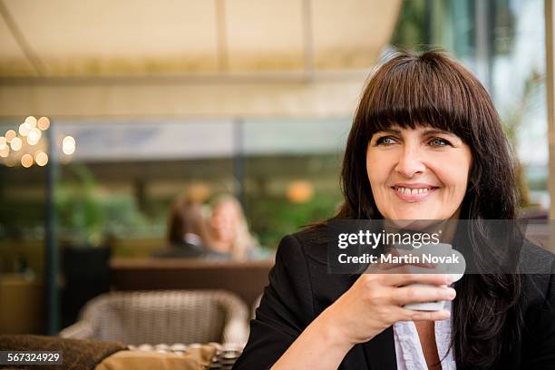 senior business woman drinking coffee outdoor - novak cafe restaurant stock pictures, royalty-free photos & images