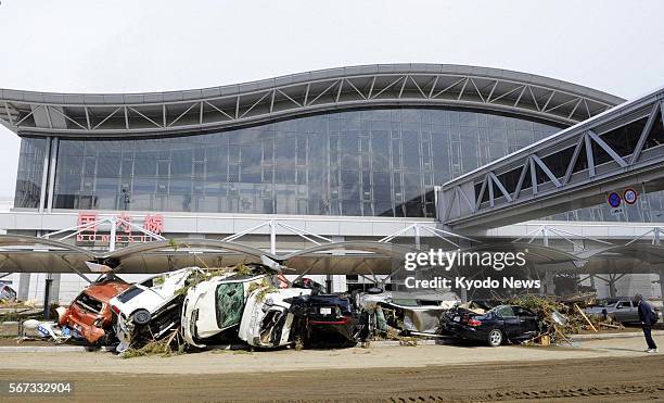 Natori, Japan - Piles of cars wrecked by tsunami are seen at Sendai airport in Miyagi Prefecture, northeastern Japan, on March 17 after the March 11...