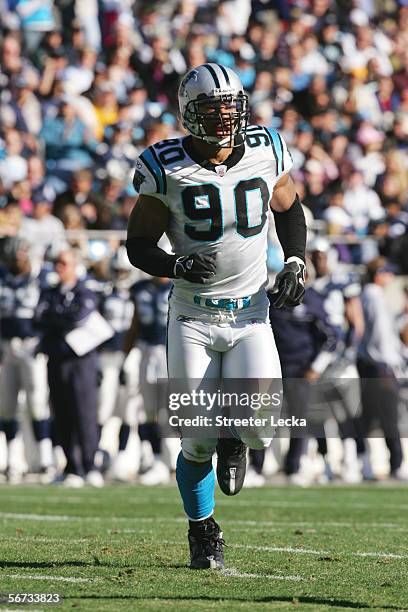 Defensive end Julius Peppers of the Carolina Panthers jogs off the field against the Dallas Cowboys at Bank of America Stadium on December 24, 2005...