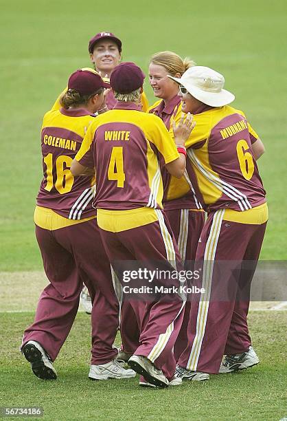 The Queensland Fire team congratulate team-mate Belinda Matheson after taking the wicket of Alex Blackwell of the NSW Breakers hits a ball to the...