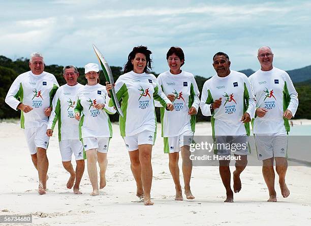 Relay runners from the Whitsundays run with the Melbourne 2006 Queen's Baton on Whitehaven Beach February 3, 2006 in The Whitsundays, Australia. The...