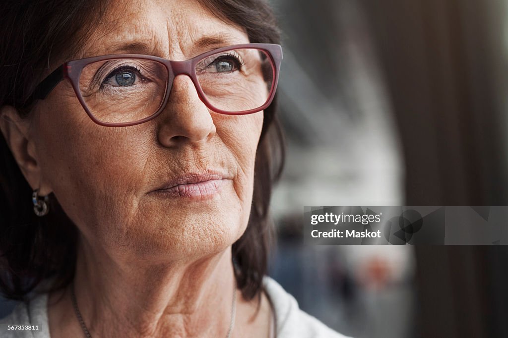 Thoughtful senior businesswoman looking away in office