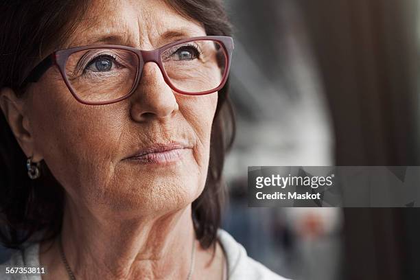 thoughtful senior businesswoman looking away in office - face look right stock pictures, royalty-free photos & images