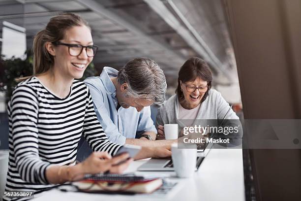 happy business people sitting at counter in office - coffee break office stock pictures, royalty-free photos & images