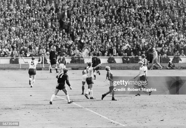 Players wait for the referee's decision after Geoff Hurst's controversial third goal for England during the World Cup Final match against West...