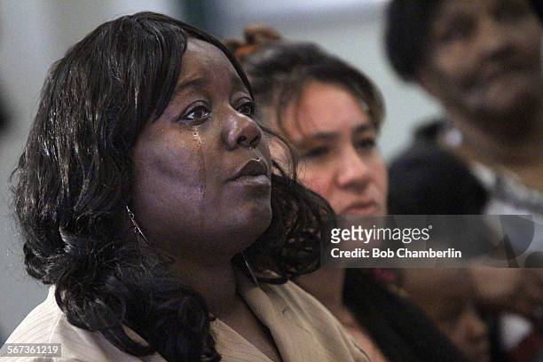 Tears run down Tawona Lee's face on FEBRUARY 05 as she watches surveillance video showing her son Bert Crump being chased down just before he was...