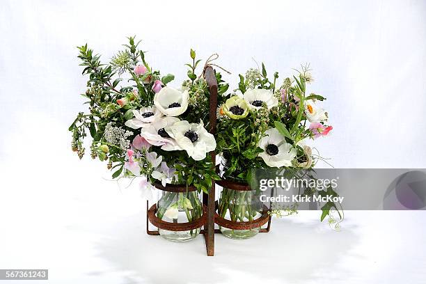 Small field-grown arrangement of white panda and pastel anemones, Queen Anne's lace, statice, wax flower, Australian rosemary, wild cucumber and...