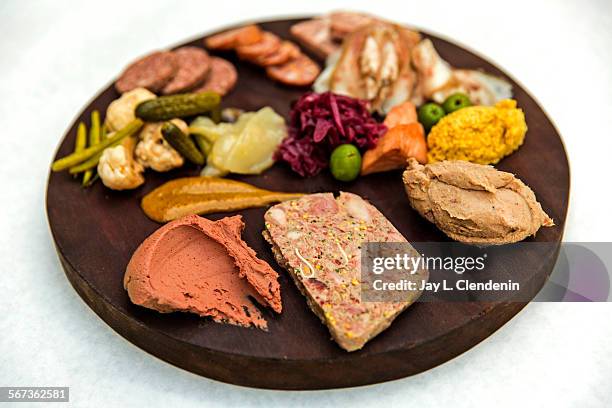 Assiette de charcuteries, with a sampling of, from front, left, truffled chicken liver, terrine de campaign, rillettes, mustard, testa, liverwurst,...