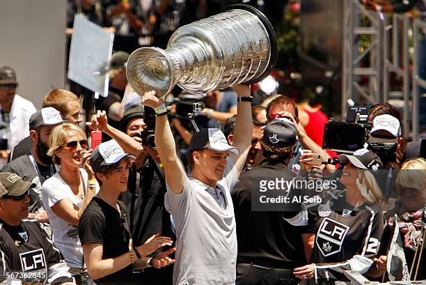 Luc Robitaille who serves as the Kings President, Business Operations lifts the Stanley Cup outside the Staples Center in downtown Los Angeles at the...