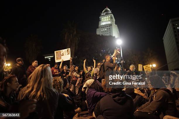 Protesters confront police officers outside the LAPD headquarters in Los Angeles during a second day of protest of the Grand Jury's decision in...