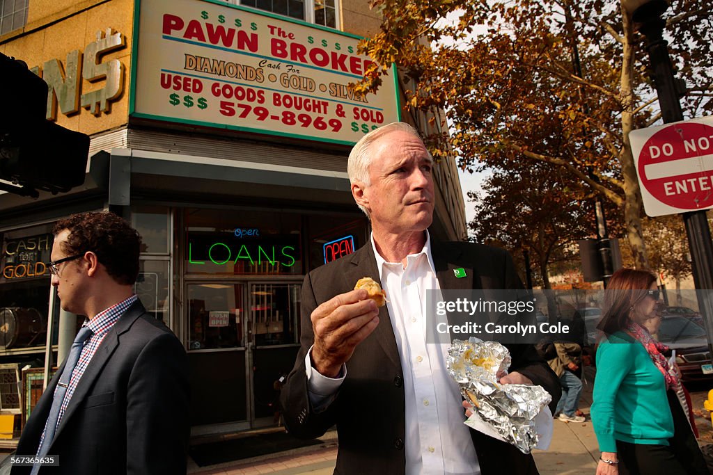 BRIDGEPORT, CONNECTICUT--OCT. 29, 2014--Bridgeport mayor, Bill Finch eats a hotdog in downtown Bridg