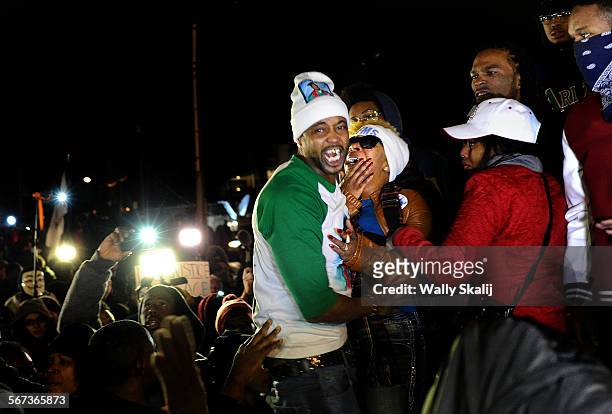 Michael Brown's mother Lesley McSpadden, center in white cap reacts to the grand jury decision outside the Ferguson police station in Ferguson,...