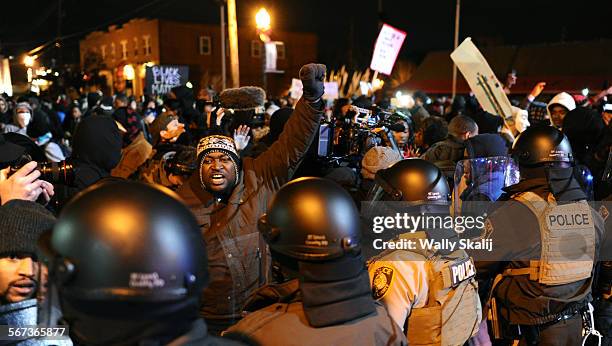 Protestors confront police on South Florissant Road after a grand jury decison in Ferguson, Missouri.