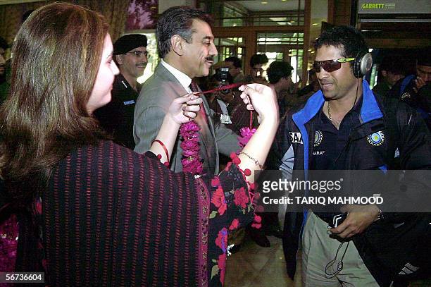Pakistani hotel employee garlands Indian cricketer Sachin Tendulkar upon his arrival in Peshawar, 03 February 2006. Indian captain Rahul Dravid said...