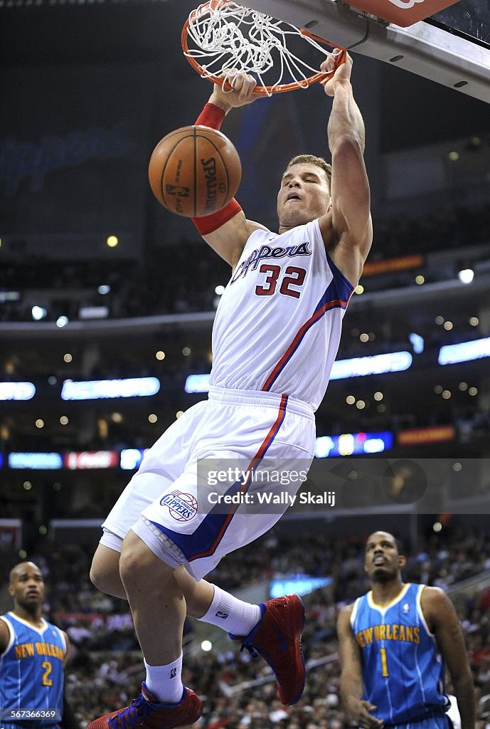 Los Angeles Clippers Blake Griffin dunks over New Orleans Hornets Jarret Jack, left, and Trevor Ariz