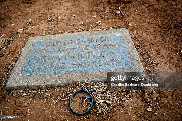 Cigarette butts and desert like conditions can be seen on a grave marker at the Evergreen Cemetery in Boyle Heights Sept. 28, 2014. The couple, who...