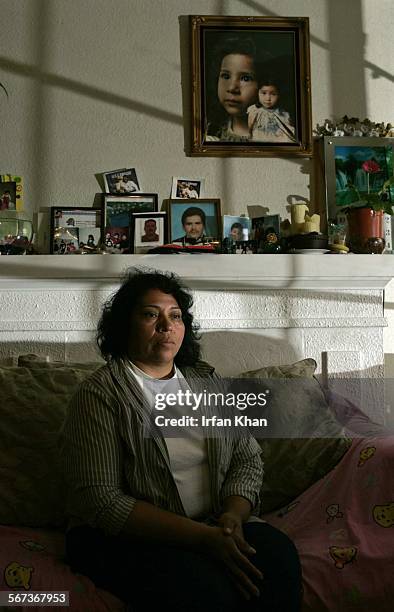 Blanca Ramirez sits by the mantle that is decorated with her husband Nasin Rivera's photos. Nasin Rivera died in San Bernardino County in august and...