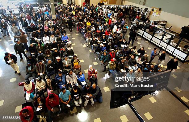 Hundreds of people without legal status line-up inside the Department Of Motor Vehicles office in Stanton, California for an opportunity to get their...