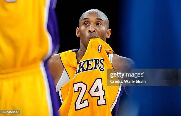 Lakers Kobe Bryant bites his jersey while Pau Gasol shoots a free throw at the Staples Center Tuesday.