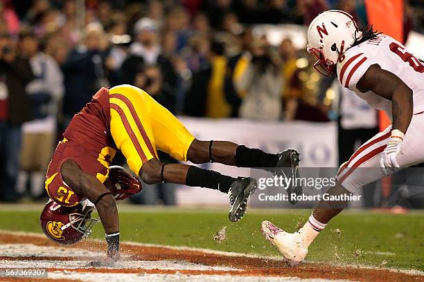 Receiver Nelson Agholor tumbles into the endzone for a touchdown reception past Nebraska safety Corey Cooper during the first half in the Holiday...