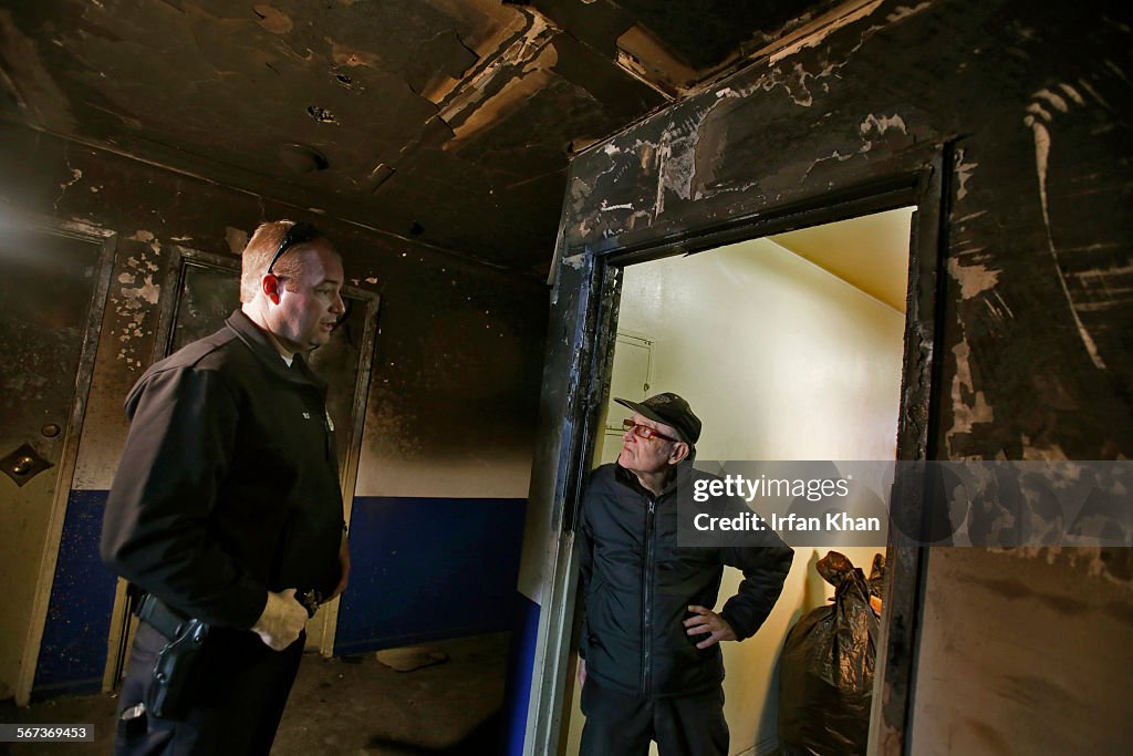 LOS ANGELES, CA DECEMBER 26, 2014 -- An LAPD officer, left, tries persuade Richard Mazzi leave apart