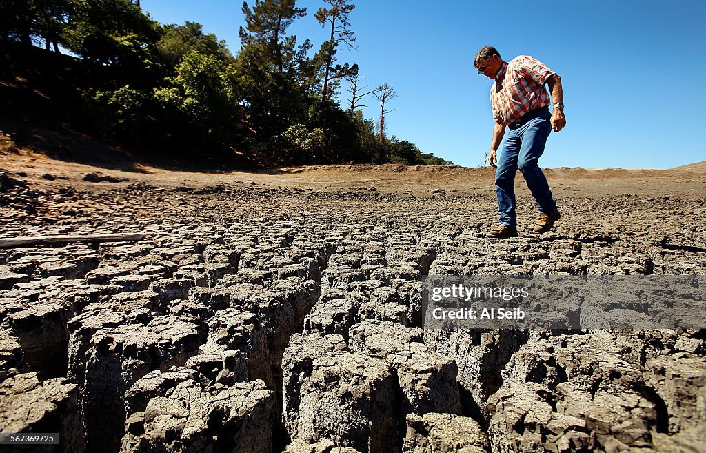 CAMBRIA, CA OCTOBER 01, 2014 - Rancher Jon Pedotti walks on the cracked remains of a parched lake