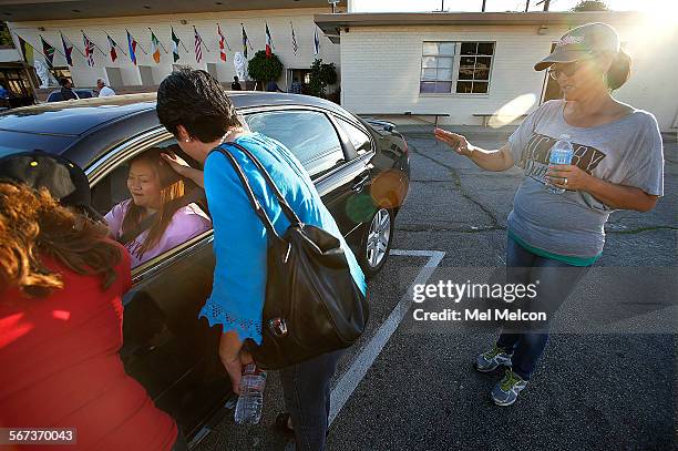 Left to right-Jackie Salas, Jocelyn Delgado, and Lucy Ramos, members of Victory Outreach of Eagle Rock Church, pray for Glory Rangel of Glassell...