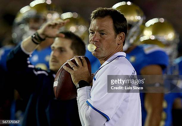Head coach Jim Mora warms up with his team before the start of the game against the New Mexico State Aggies on Saturday, Sept. 21 at the Rose Bowl in...