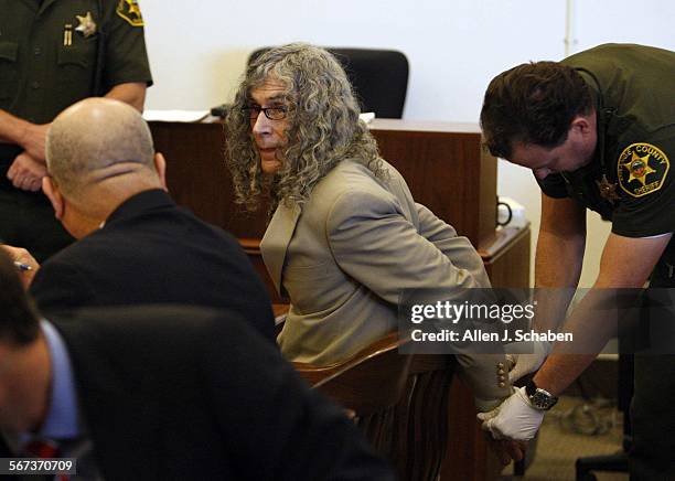 Convicted serial killer Rodney James Alcala confers with his investigator, Alfredo Rasch, while getting his handcuffs removed. Alcala was convicted...