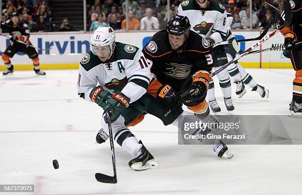 Anaheim Ducks left wing Matt Beleskey can't keep the offense going as Minnesota Wild Zach Parise clears the puck in the second period at Honda Center...