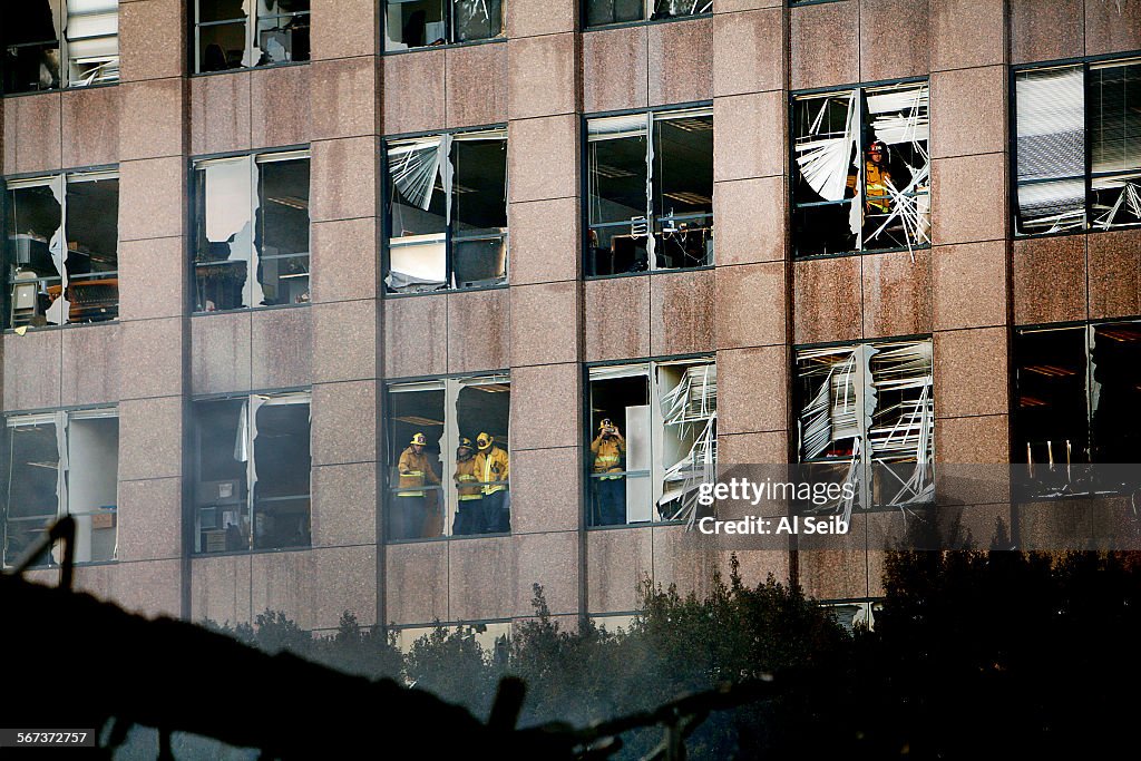 LOS ANGELES, CA DECEMBER 8, 2014 -- LA City firefighters look out from the windows of the office bui