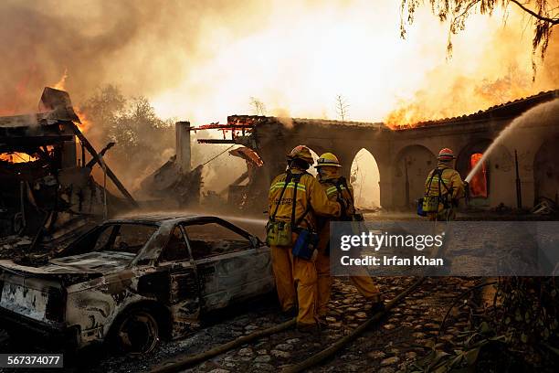 Fire fighters try to protect main house as fire burns a section of Singer Mansion located at Kregmont Dr. In Glendora. The Colby fire that broke out...