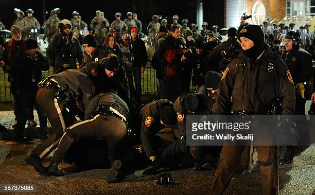 Police arrest a protestor outside the Ferguson police station in Missouri Tuesday.