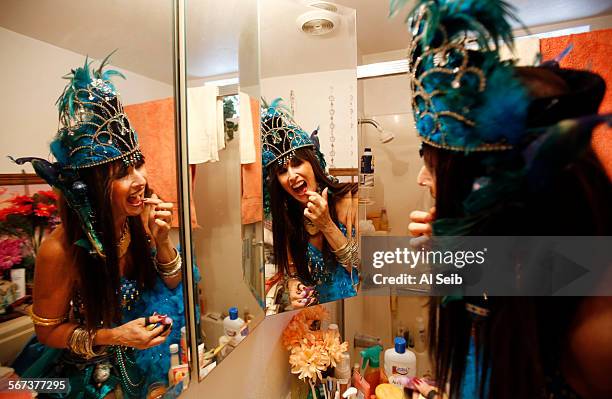 Nancy Urbach, also known as Queen Narayana puts on final touches while readying her belly dancing moves at her Pasadena home on Friday November 14,...