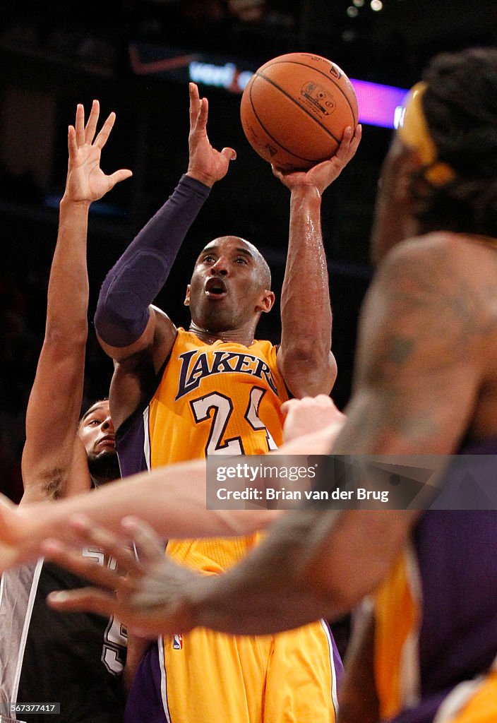 LOS ANGELES, CA - NOVEMBER 14, 2014:  Kobe Bryant shoots in traffic during fourth quarter as the Lak