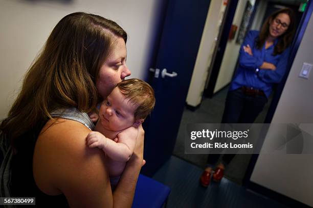 Dr. Lisa Stern right, a pediatrician, talks with Christa McCaffrey, of Santa Monica, about her 2-month old, Olive McCaffrey, who visited the clinic...