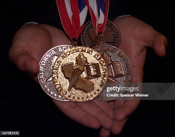 Simi Valley High School Academic Decathlon team member Steve Mihalovits displays his medals as Simi Valley team celebrates their winning the State...