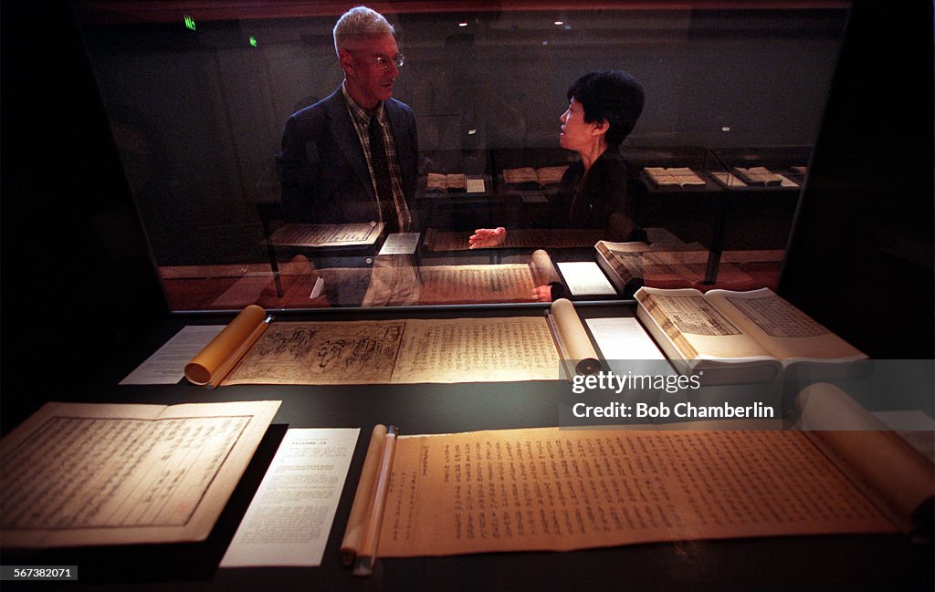 Classical Chinese language and literature professor Richard Strassberg of UCLA (left) discusses exhi