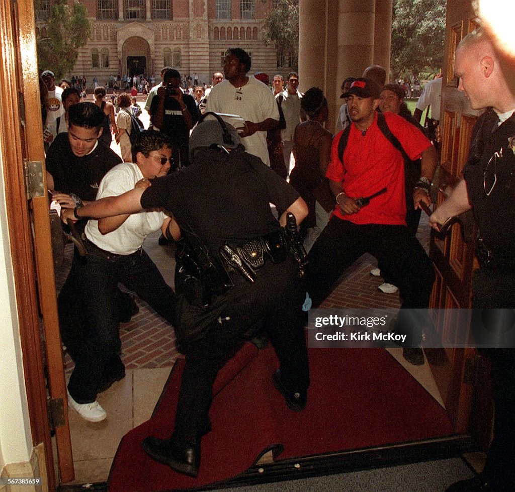 ME.MALCOLM.2.0519.KMStudents try to push their way past the campus police in an attempt to take ov