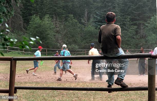 Cowley.#5.0819.BC/cTeague Cowley sits on fence and watches game of "ultimate frisbee" at burn camp at Cheley Colorado Camp in Glen Haven.