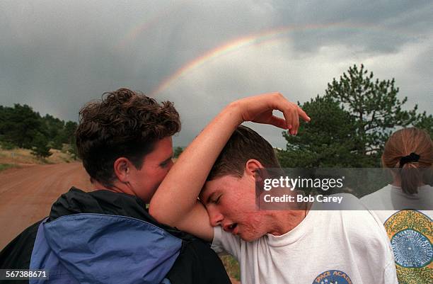 Cowley.#12.0819.BC/cTeague Cowley leans on Stephanie Manley's shoulder as they view rainbow. They just finished daylong hike into Rockies from...