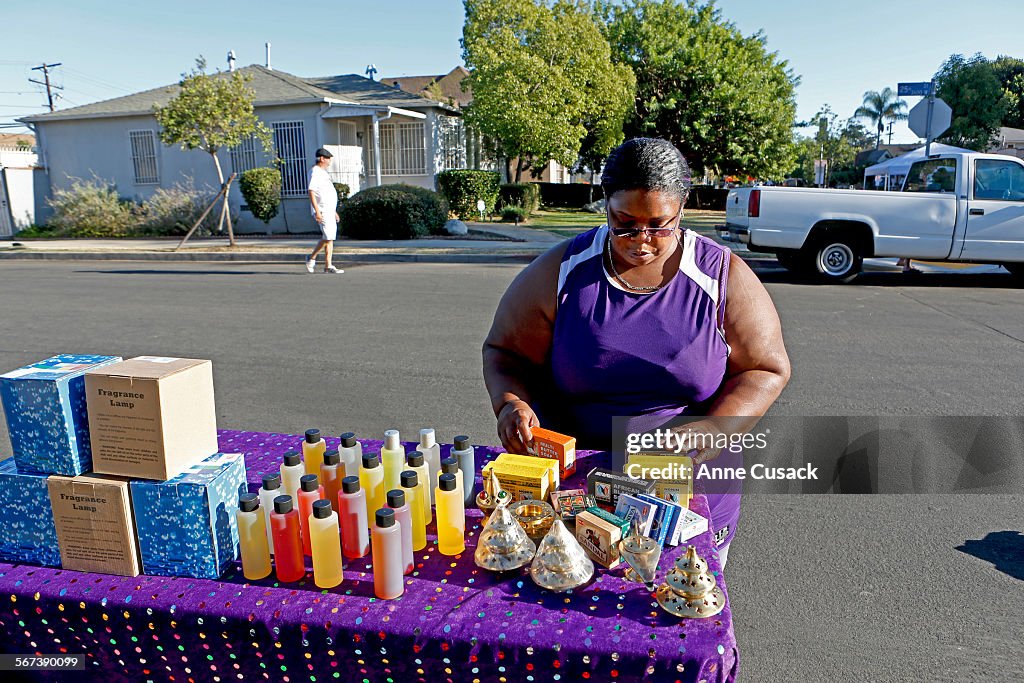 LOS ANGELES, CA.-AUGUST 29, 2014:  Jackie Lloyd sets up her street vendor booth in Exposition Park i